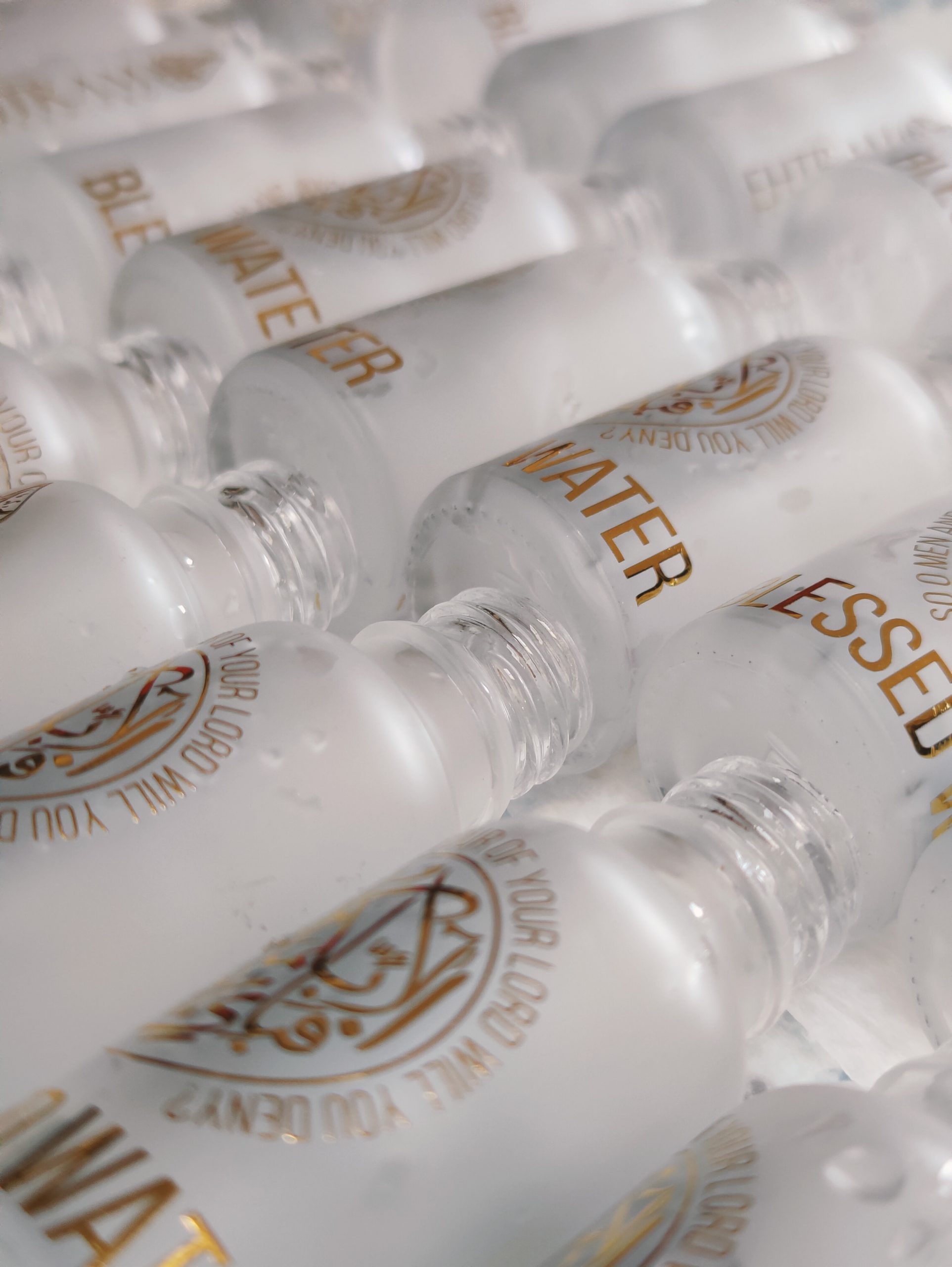 Collection of Ehtram Blessed Water bottles with gold branding