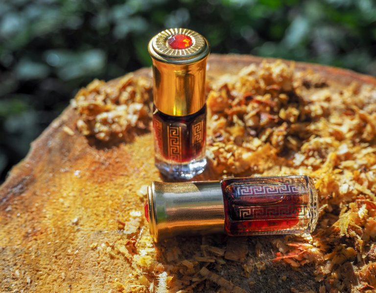 bottle-oil-agarwood-tree-against-bark-oil-oudh